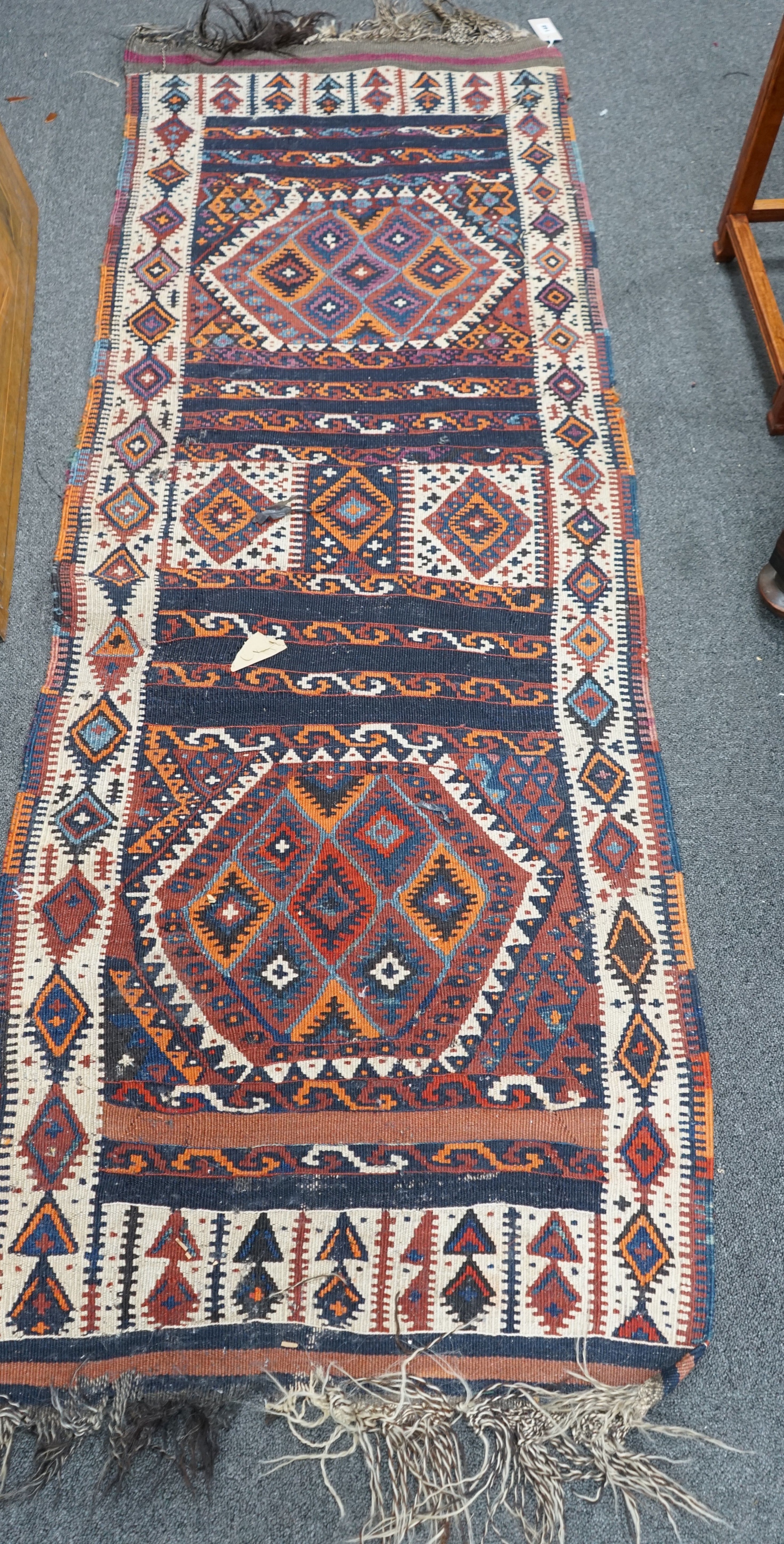 A polychrome geometric flatweave runner, 190 x 70cm